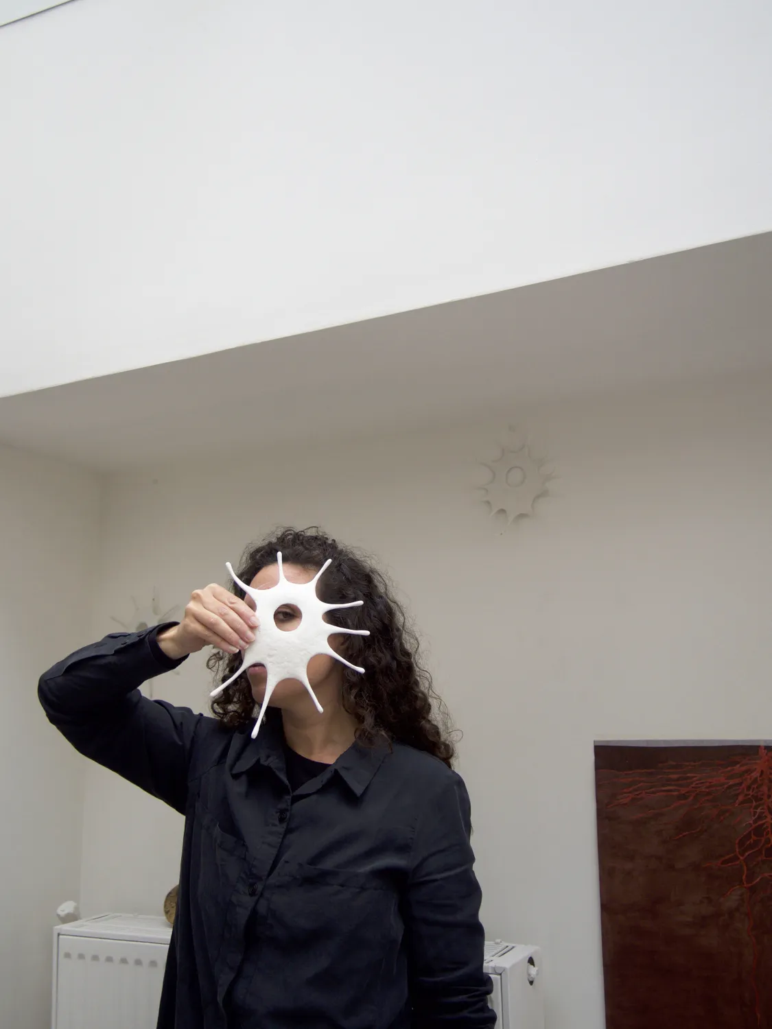 Camila Jordan holding plaster sculpture in studio, Paris