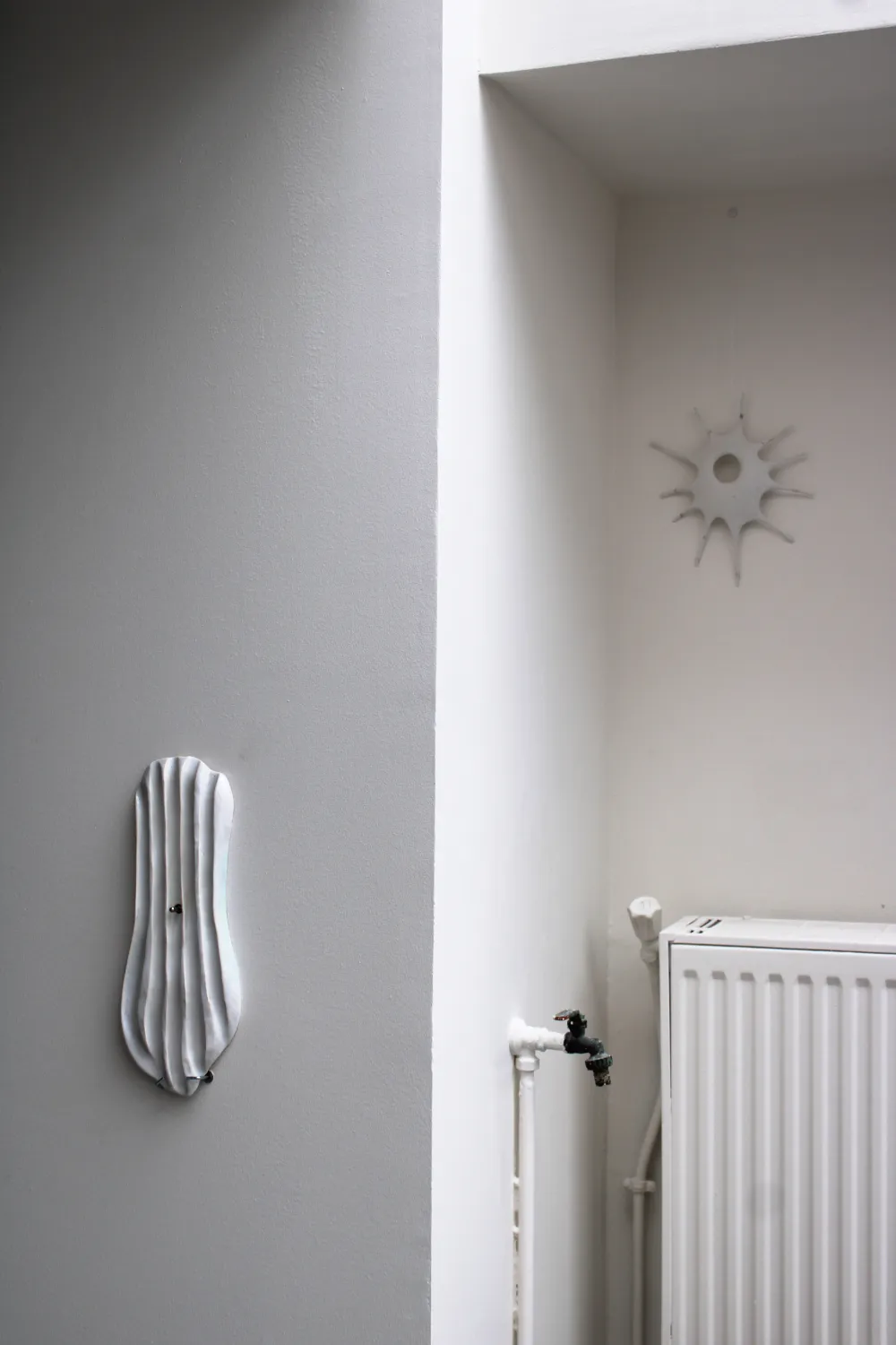 Sculpture installation with works on studio walls, Paris