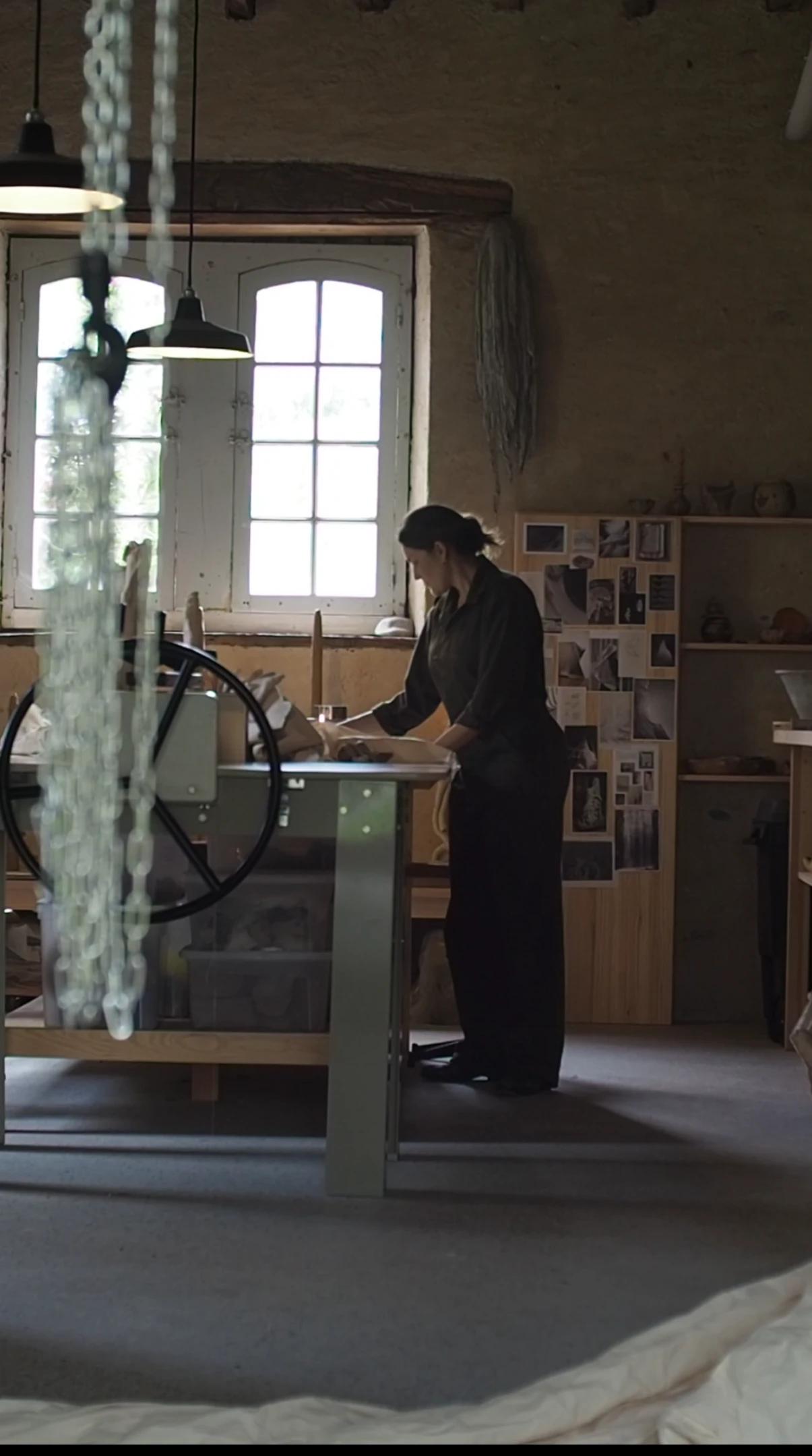 Johanna Meyer working at a table in her studio