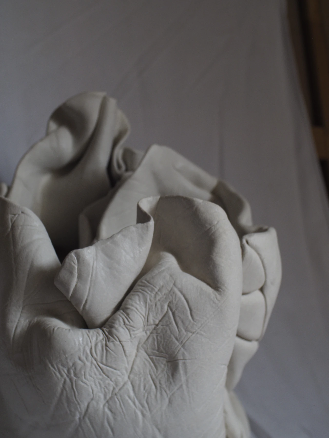 Close-up detail of porcelain surface showing textile imprint texture