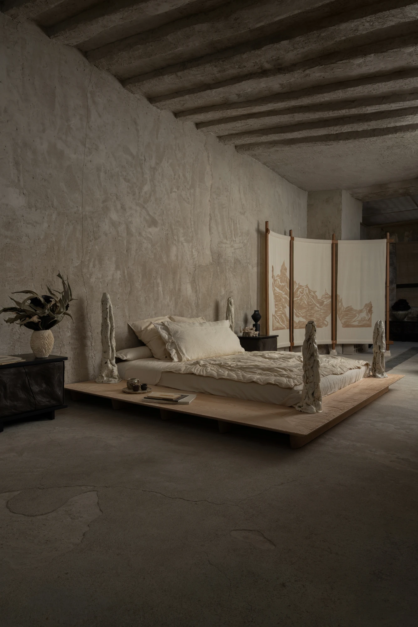 Ceramic sculptures as bedposts in a bedroom installation at La Lune Galerie