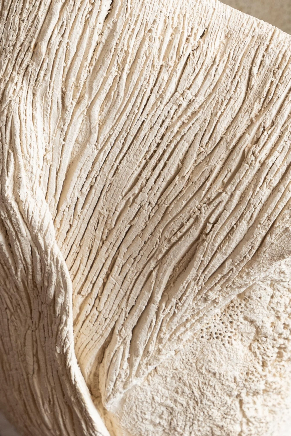 Close-up of white clay ceramic surface with bark-like texture